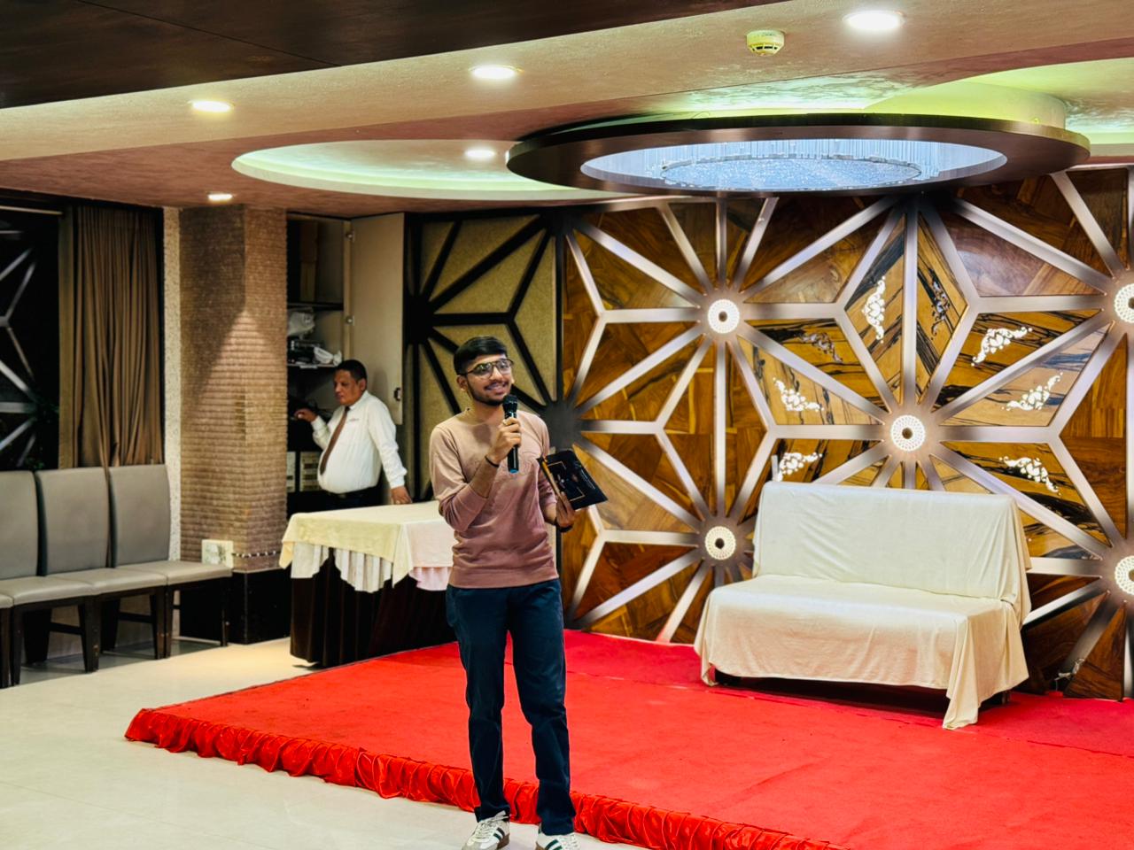 Elegant event setup with hosting area and floral arrangements